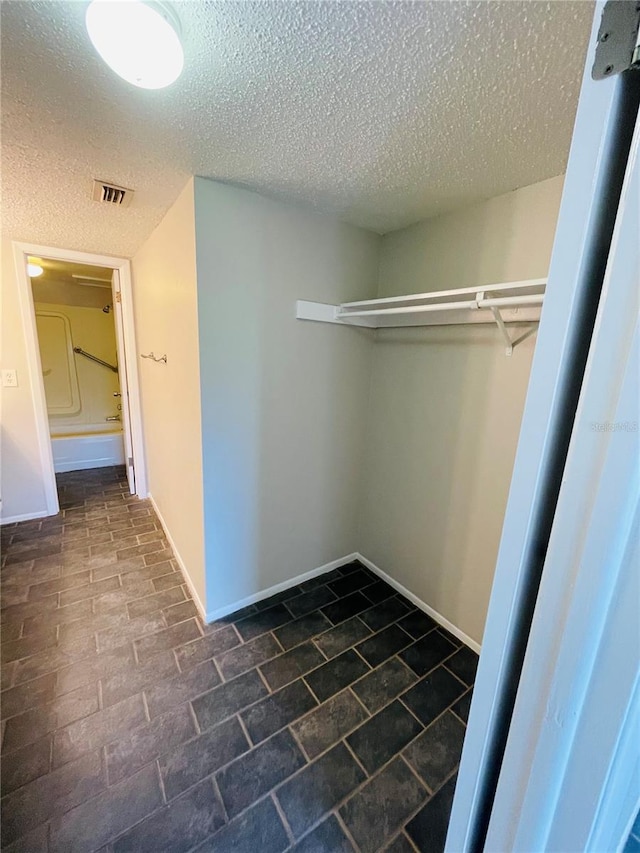 walk in closet featuring visible vents