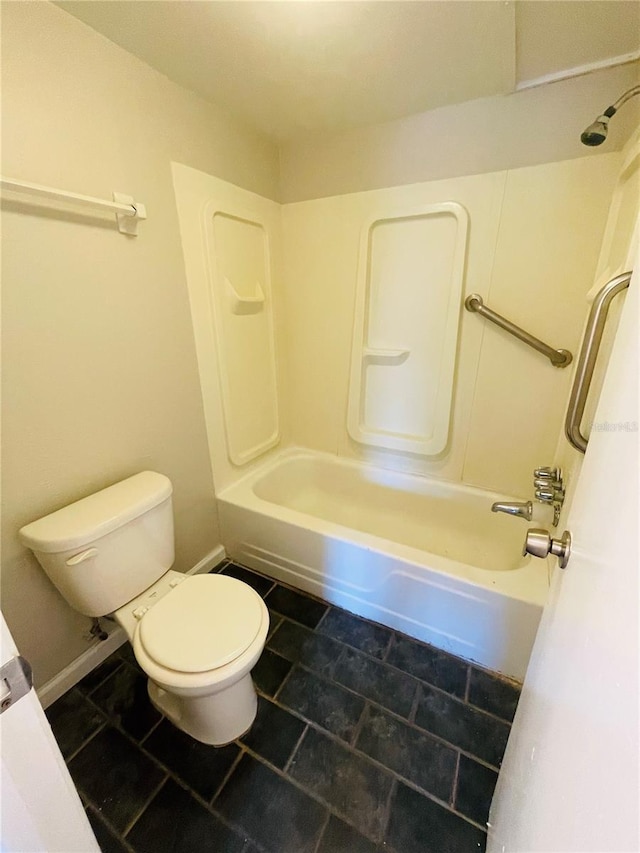 bathroom with shower / washtub combination, toilet, and baseboards