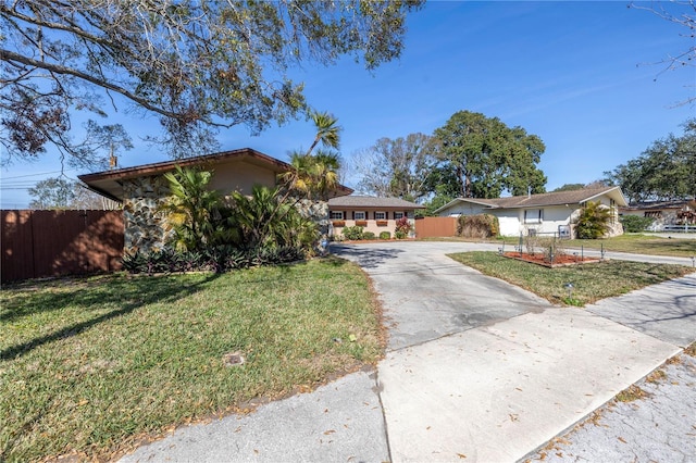 ranch-style home with a front lawn