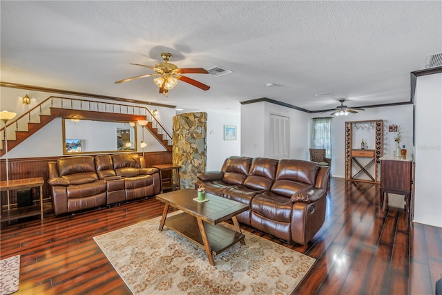 living room with ornamental molding, dark hardwood / wood-style floors, ceiling fan, and a textured ceiling