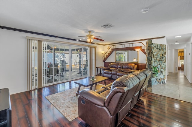 living room featuring hardwood / wood-style flooring, ornamental molding, ceiling fan, and a textured ceiling