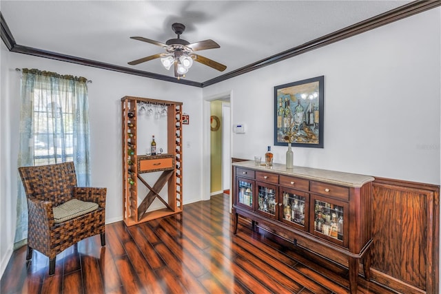 living area with ceiling fan, ornamental molding, and dark hardwood / wood-style floors