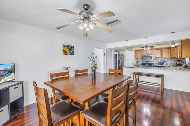 dining space featuring ceiling fan, dark hardwood / wood-style floors, and sink