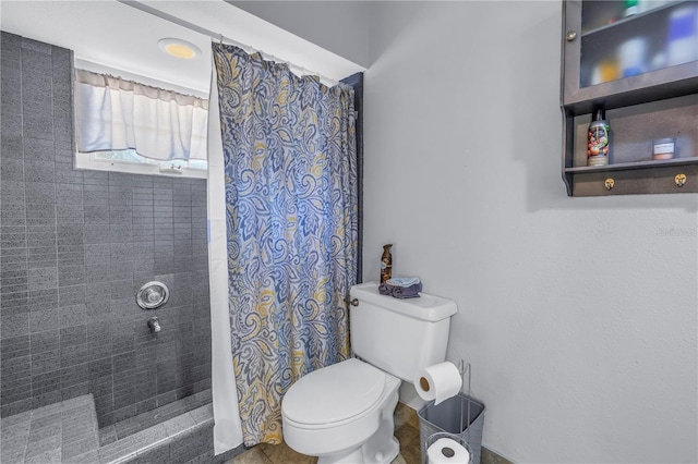 bathroom with toilet and walk in shower