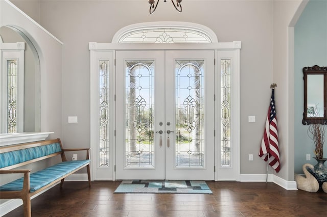 foyer featuring dark wood-type flooring, french doors, and a healthy amount of sunlight