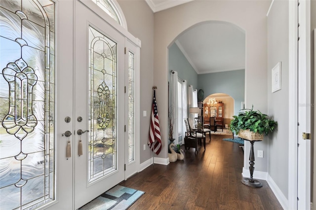 foyer entrance with dark wood-type flooring and ornamental molding