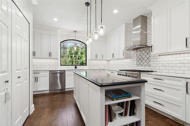 kitchen featuring wall chimney range hood, stainless steel dishwasher, and white cabinets