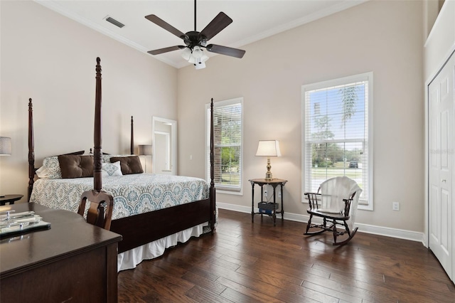 bedroom with ornamental molding, dark hardwood / wood-style floors, and a closet