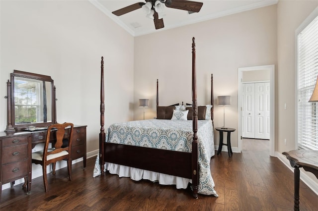 bedroom with dark hardwood / wood-style flooring, crown molding, ceiling fan, and a high ceiling