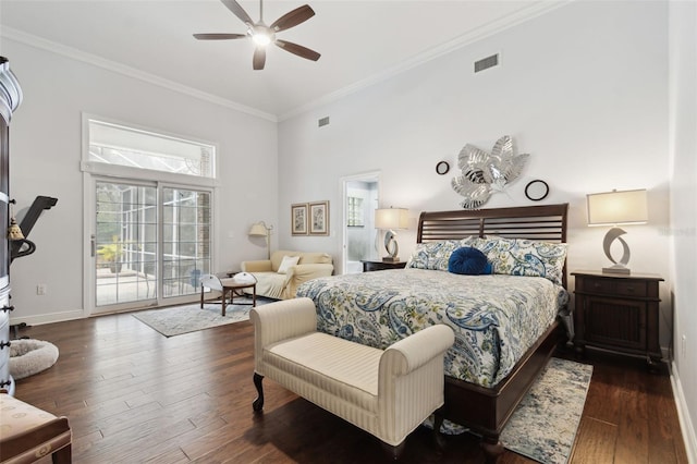 bedroom featuring multiple windows, access to exterior, crown molding, and dark wood-type flooring