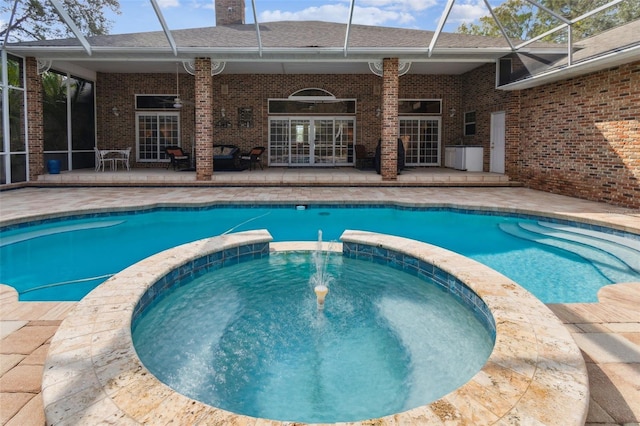 view of swimming pool featuring an in ground hot tub, ceiling fan, and a patio