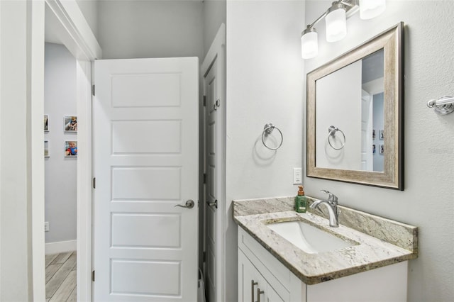 bathroom featuring vanity and wood-type flooring