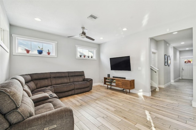 living room featuring light hardwood / wood-style floors and ceiling fan