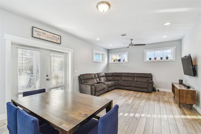 dining room with ceiling fan and light hardwood / wood-style flooring