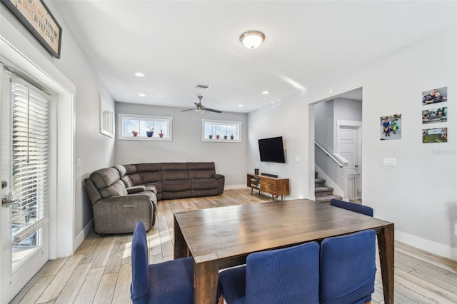 living room with ceiling fan and light hardwood / wood-style flooring