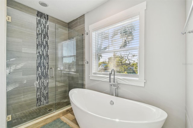 bathroom featuring separate shower and tub