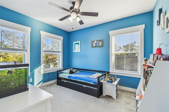 bedroom featuring light carpet and ceiling fan