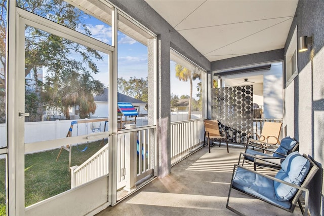 sunroom / solarium with a water view