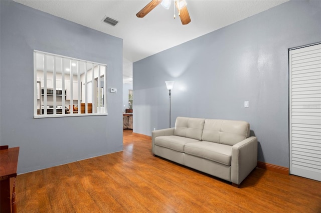 living room featuring hardwood / wood-style flooring and ceiling fan