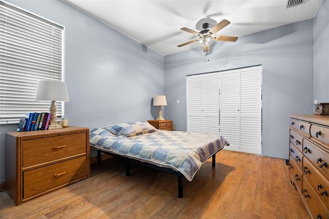 bedroom with light hardwood / wood-style floors and ceiling fan