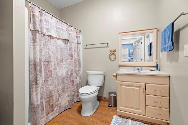 bathroom featuring vanity, hardwood / wood-style floors, toilet, and a shower with shower curtain