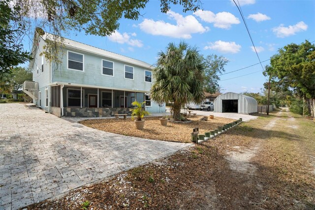 view of front of home featuring a garage and an outdoor structure