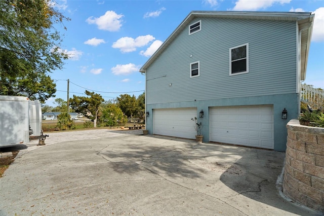 view of side of home with a garage