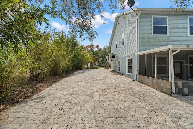 view of side of property with a sunroom