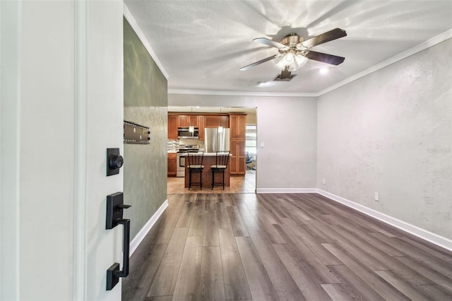 living room featuring wood-type flooring, a textured ceiling, ceiling fan, and crown molding