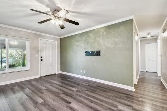 foyer with ornamental molding, dark hardwood / wood-style floors, and ceiling fan