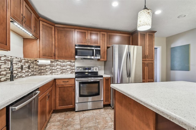 kitchen with hanging light fixtures, tasteful backsplash, appliances with stainless steel finishes, and sink