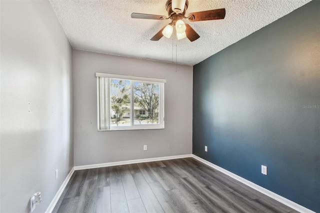 unfurnished room featuring ceiling fan, dark hardwood / wood-style floors, and a textured ceiling