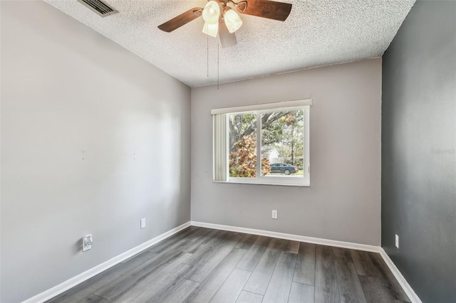 empty room featuring ceiling fan, wood-type flooring, and a textured ceiling