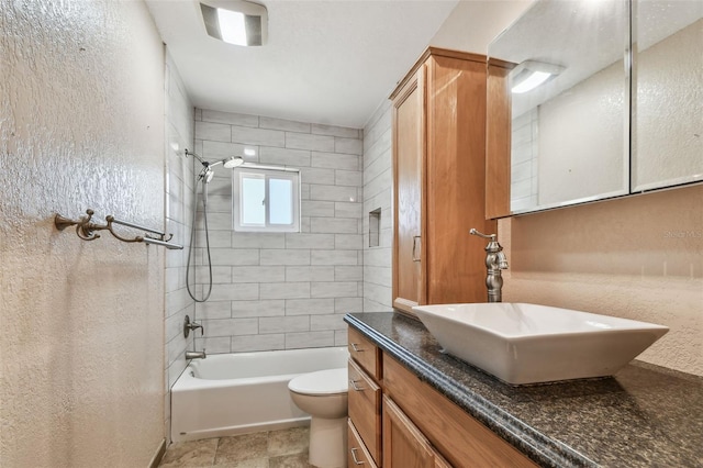 full bathroom with vanity, toilet, and tiled shower / bath combo