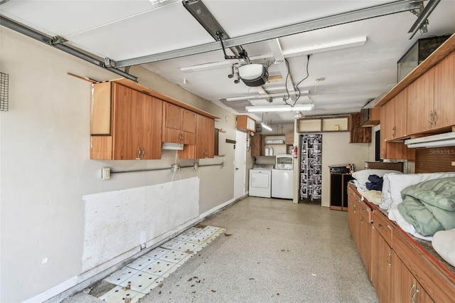 garage featuring washing machine and clothes dryer and a garage door opener