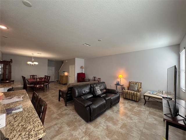 20314 Starfinder Way, Tampa, FL 33647 - living room featuring a textured ceiling and a notable chandelier