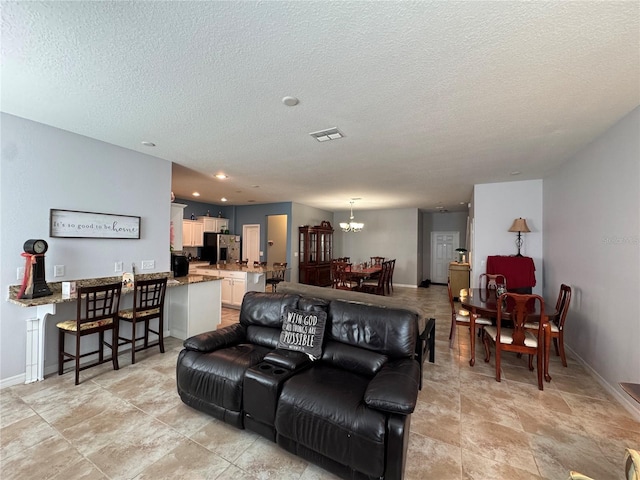 20314 Starfinder Way, Tampa, FL 33647 - living room with a textured ceiling and a chandelier