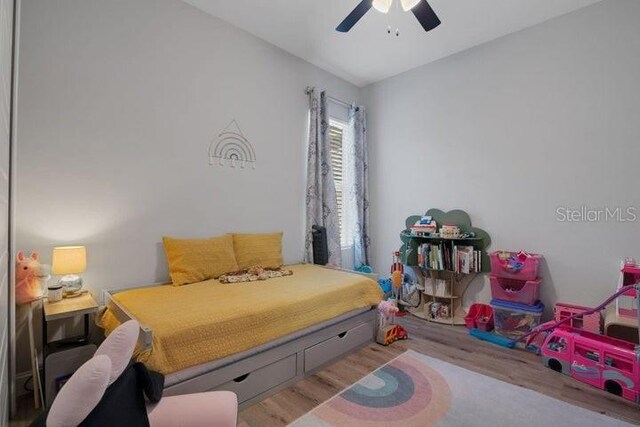 bedroom with ceiling fan and light hardwood / wood-style floors