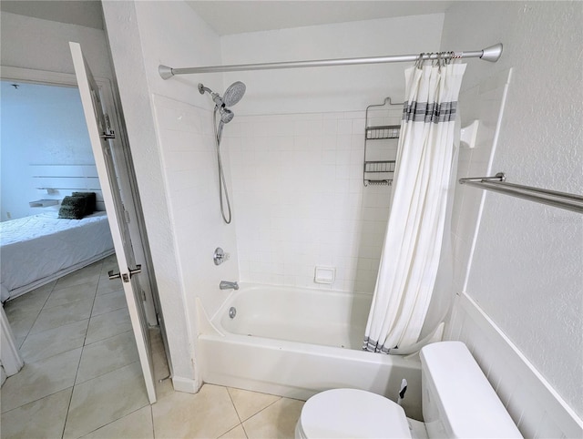 bathroom with shower / bath combination with curtain, tile patterned floors, and toilet