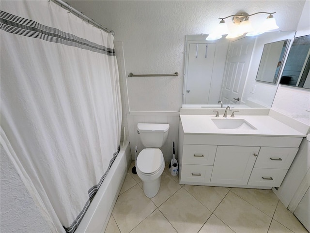 full bathroom featuring vanity, shower / tub combo, tile patterned floors, and toilet