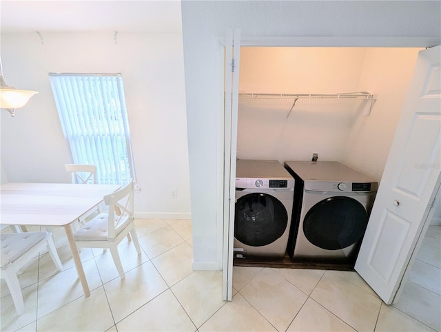 washroom with light tile patterned floors and independent washer and dryer