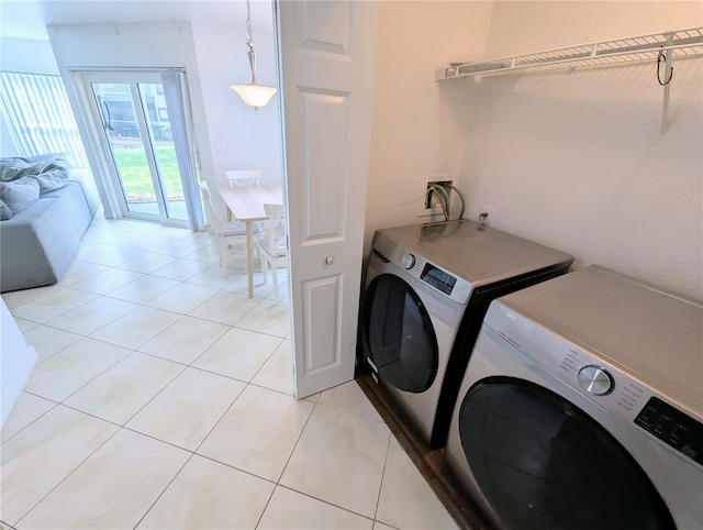 washroom featuring independent washer and dryer and light tile patterned flooring