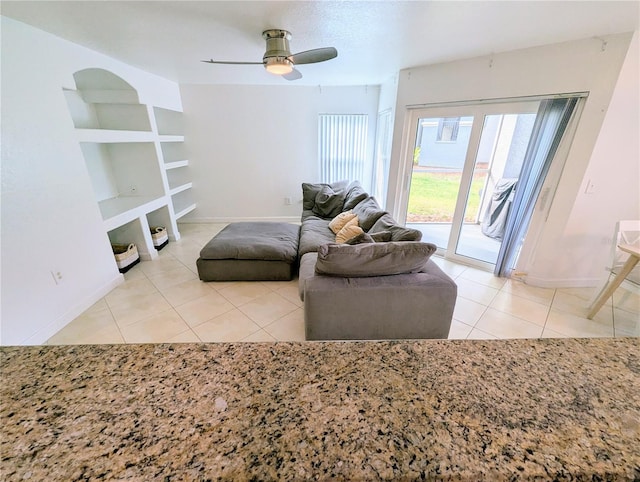 tiled living room featuring ceiling fan