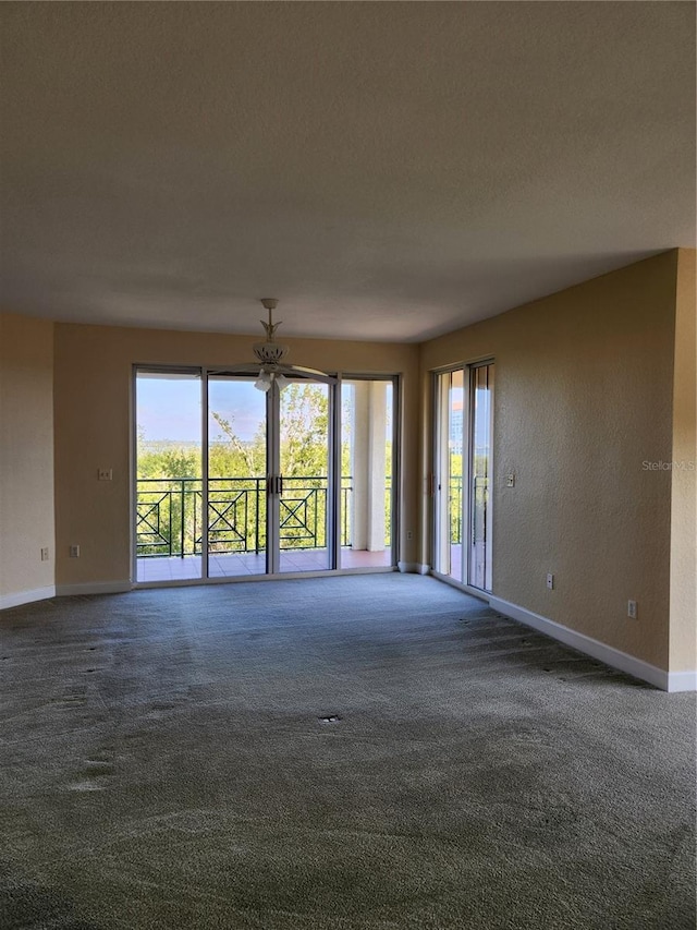 unfurnished room with dark colored carpet