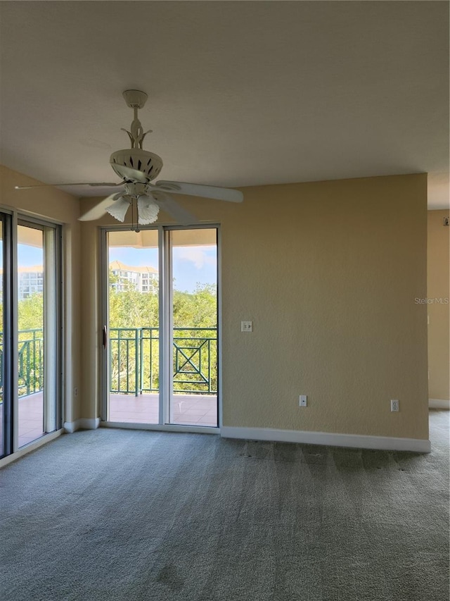 empty room featuring ceiling fan and carpet flooring