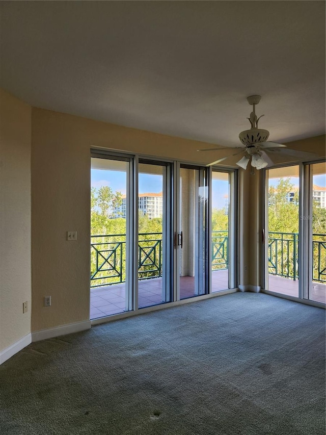 spare room featuring ceiling fan, plenty of natural light, and carpet