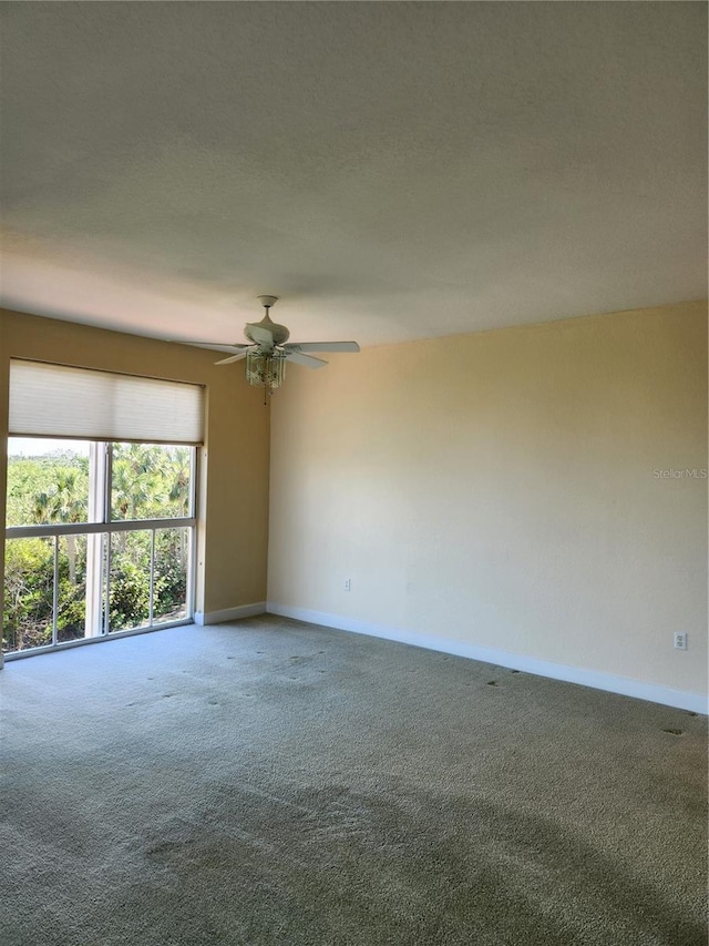 spare room with carpet and ceiling fan