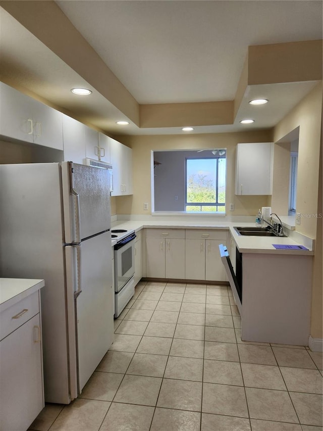 kitchen featuring white cabinetry, sink, white appliances, and light tile patterned floors