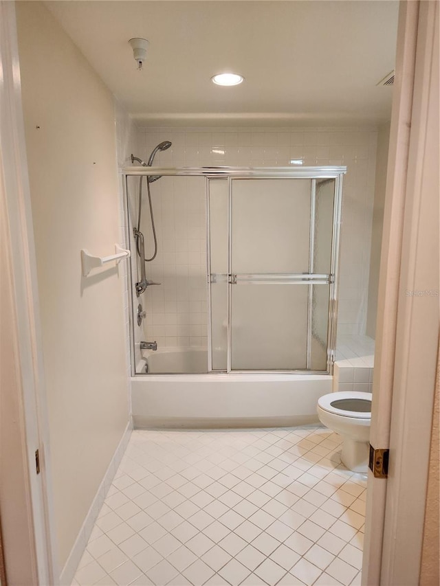 bathroom with tile patterned flooring, enclosed tub / shower combo, and toilet