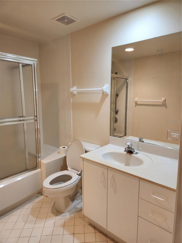 full bathroom with tile patterned flooring, vanity, combined bath / shower with glass door, and toilet